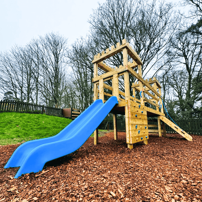 Playset with blue slide and climbing wall