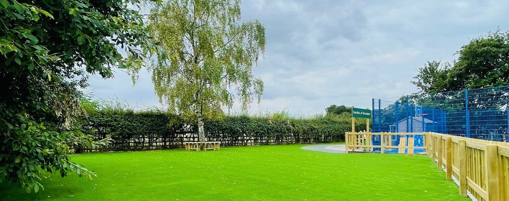 Play area with trees and fencing
