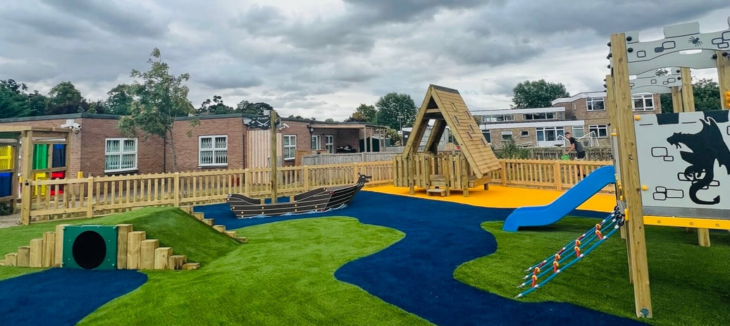Play area with slide, boat and climbing equipment