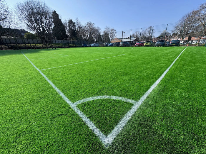 Artificial Grass Football pitch with cars parked up in the background