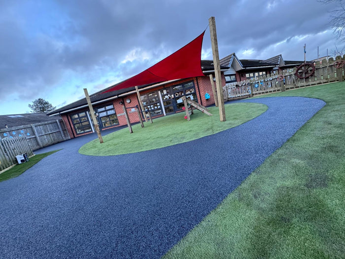 Rubber Wet Pour installed at a playground with a red canopy